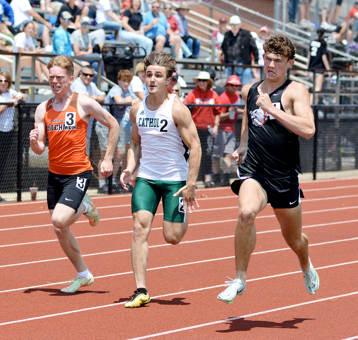 Charlie Whelan (far left) sprints towards the finish line in the boys 100m dash. Whelan placed fifth in the event before bouncing back to qualify for state in the boys 200m dash after a fourth-place finish.